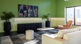 a clubroom with a tv, couch and tables