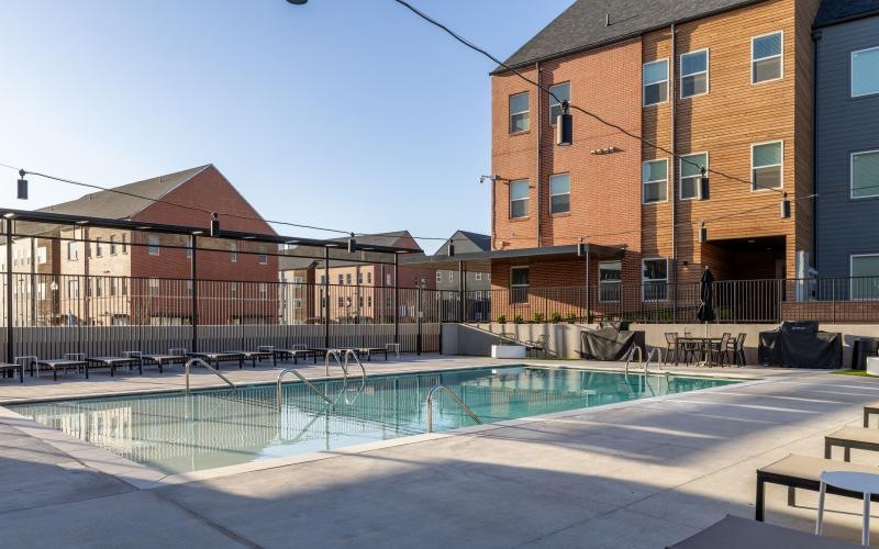 a swimming pool in a courtyard between buildings