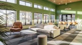 a room with a couch and chairs